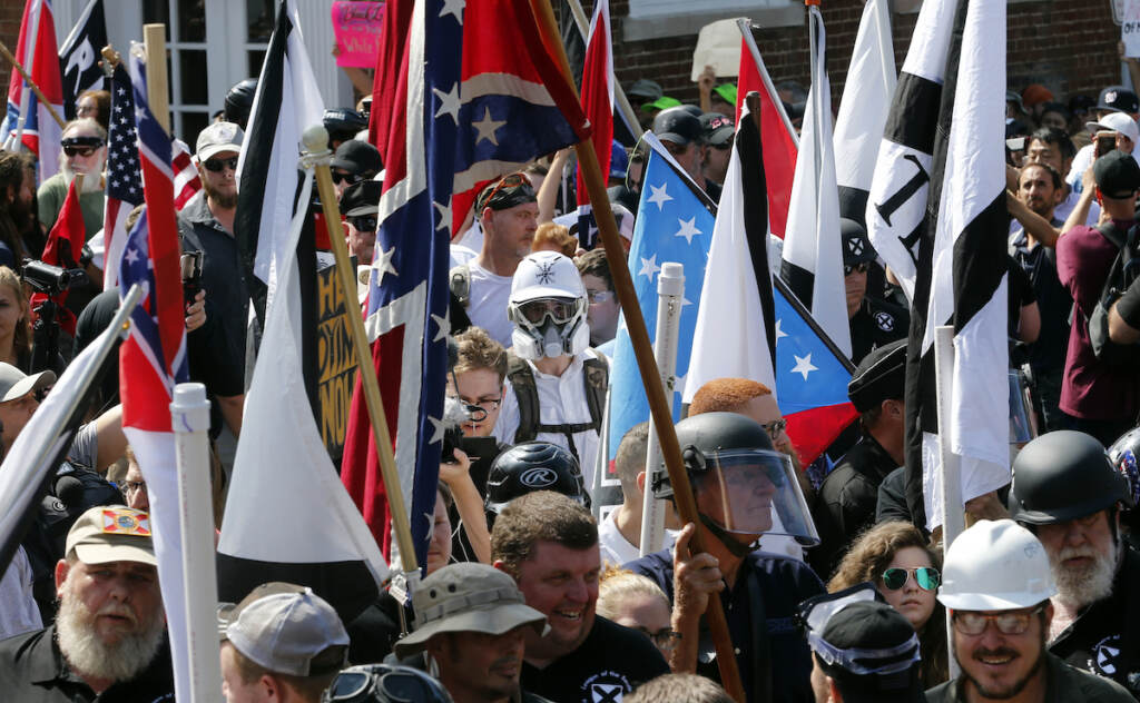Unite the Right Rally-Trial Alt Right demonstrators walk into the entrance of Lee Park surrounded by counter demonstrators in Charlottesville, Va., Saturday, Aug. 12, 2017
