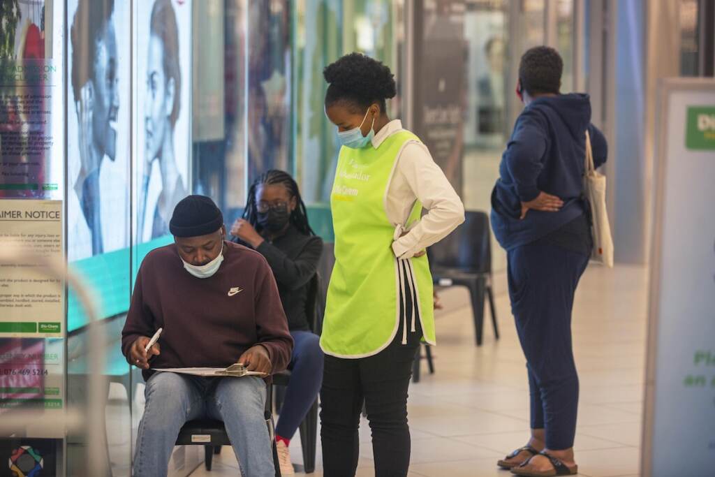 Virus Outbreak New Variant People lineup to get vaccinated at a shopping mall in Johannesburg, South Africa, Friday Nov. 26, 2021. A new coronavirus variant has been detected in South Africa that scientists say is a concern because of its high number of mutations and rapid spread among young people in Gauteng, the country’s most populous province