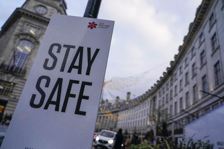A sign reading ’Stay safe’ in Regent Street, in London, Friday, Nov. 26, 2021. A slew of nations moved to stop air travel from southern Africa on Friday, and stocks plunged in Asia and Europe in reaction to news of a new, potentially more transmissible COVID-19 variant
