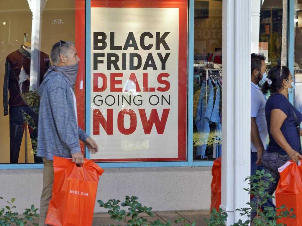 Shoppers wear protective face masks as they look for Black Friday deals at the Ellenton Premium Outlet stores Friday, Nov. 27, 2020, in Ellenton, Fla. Shoppers wear protective face masks as they look for Black Friday deals at the Ellenton Premium Outlet stores Friday, Nov. 27, 2020, in Ellenton, Fla. (AP Photo/Chris O'Meara, file)