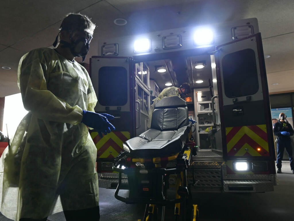 South Metro Firefighters work amidst coronavirus. Firefighter Chris Herrington begins to take off his personal protective equipment as he and his partner John Cronin, in ambulance, wait for a