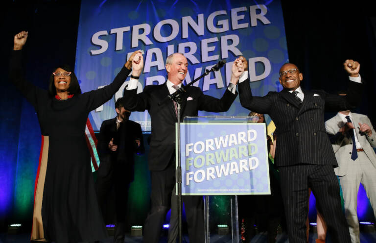 Lt. Gov. Sheila Oliver, left, New Jersey Governor, Phil Murphy center, and LeRoy Jones, chairman of the state's Democratic committee, right, celebrate at Convention Hall after winning gubernatorial race against Jack Ciattarelli. 
Wednesday, Nov. 3, 2021, in Asbury Park, N.J. 
(AP Photo/Noah K. Murray)