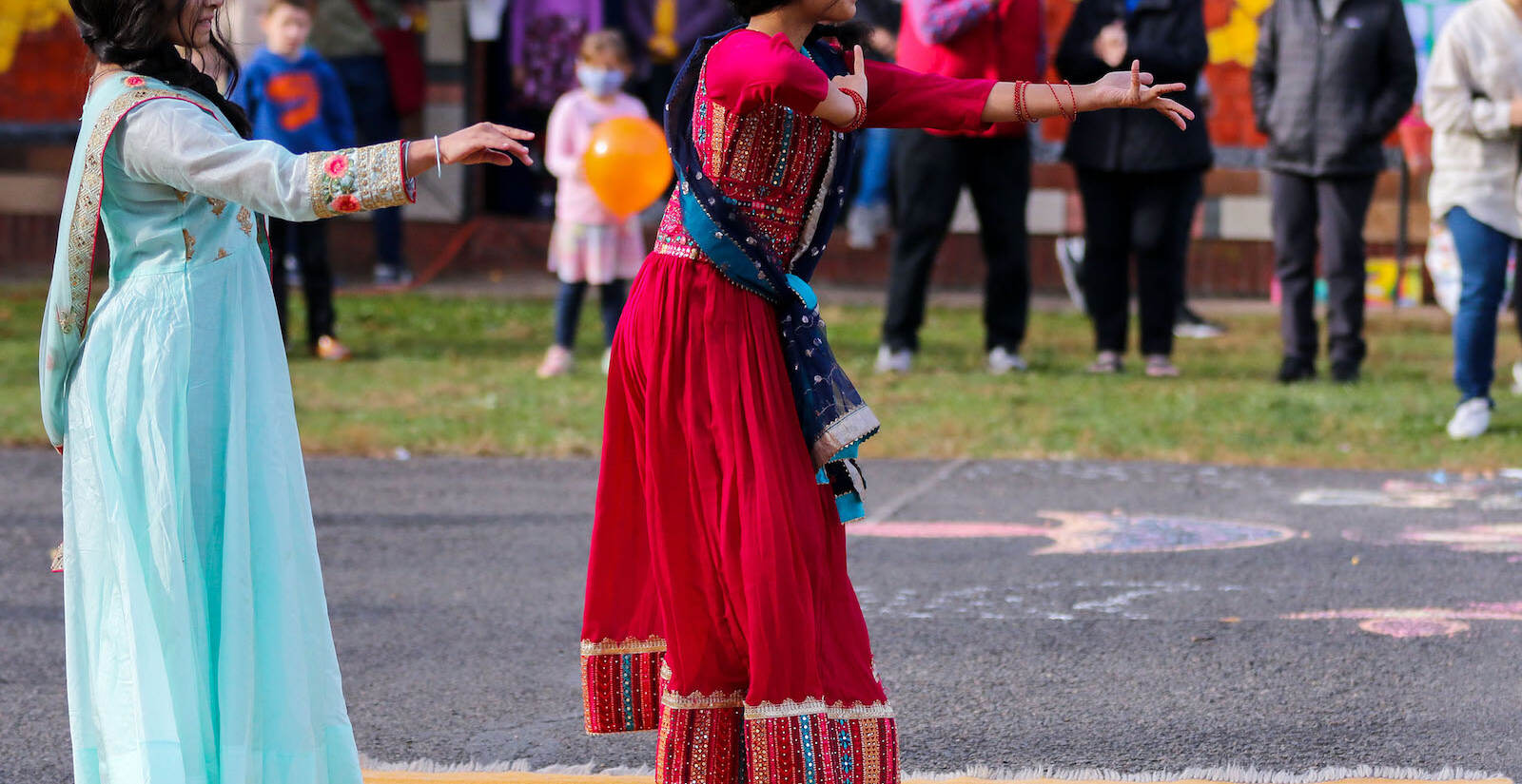 Saanvi Potnis (left) and Arya Haridas (right), of Doylestown, dancing at the first annual Diwali festival in Doylestown on Nov. 7, 2021. (Daniella Heminghaus for WHYY)