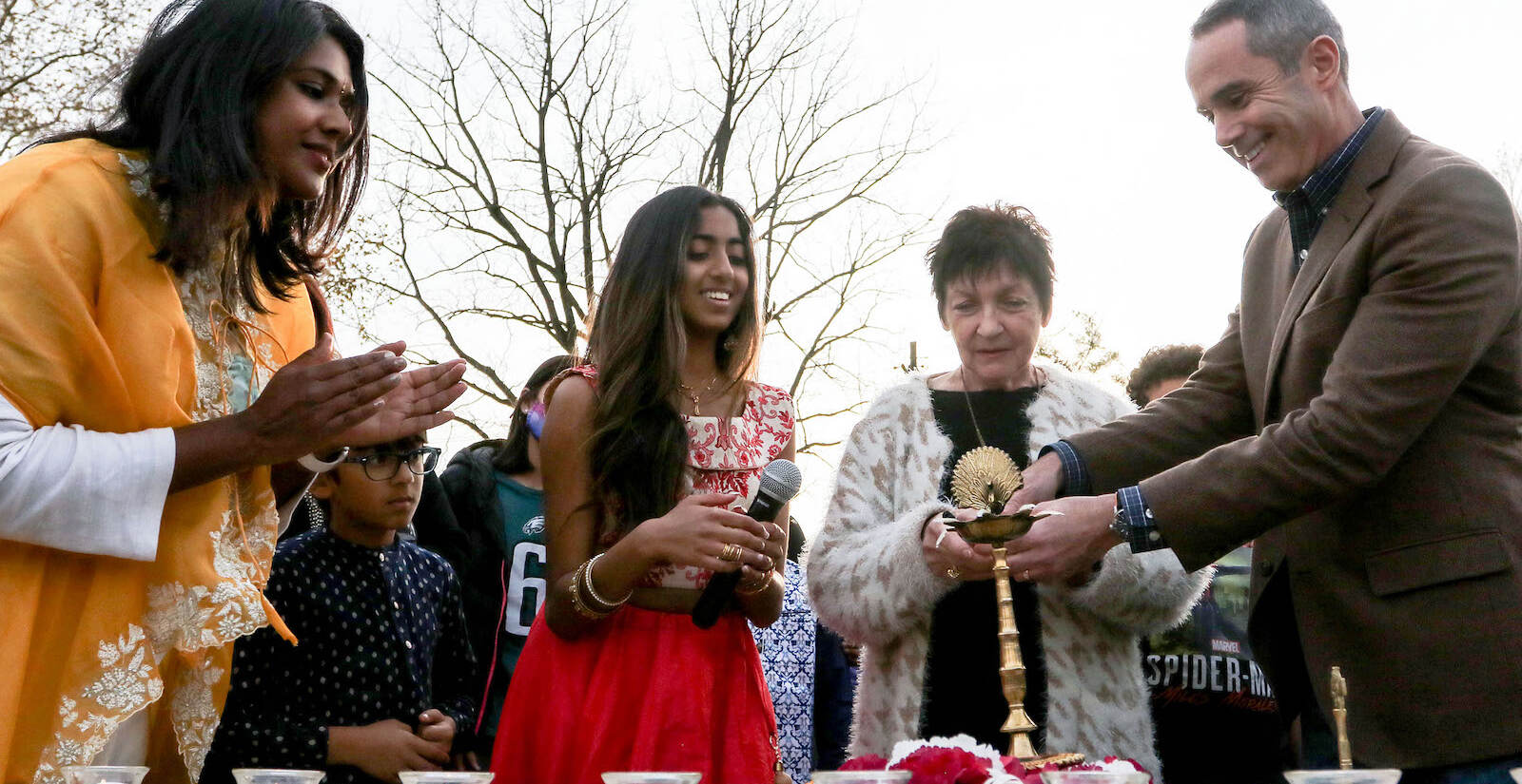 Left to right: Silvi Haldipur, from Desis of Doylestown; Paree Pasi, from Youth4Unity; Mayor-elect Noni West; and Sen. Steven Santarsiero lighting the Diya at the first annual Diwali festival in Doylestown on Nov. 7, 2021. (Daniella Heminghaus for WHYY)