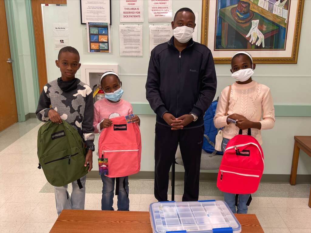 Ismail RISE Family at Westside Health 100621 A father and his children pose for pictures after getting backpacks with school supplies at a visit with a local Delaware health care provider. (Courtesy of Jewish Family Services of Delaware)