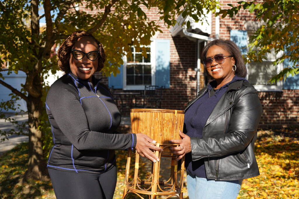 Jessica Pointer (L) accepts a gift, a plant stand, from Lisa Ivery (R) on a sunny, fall morning Jessica Pointer (L) accepts a gift, a plant stand, from Lisa Ivery (R) on a sunny, fall morning.