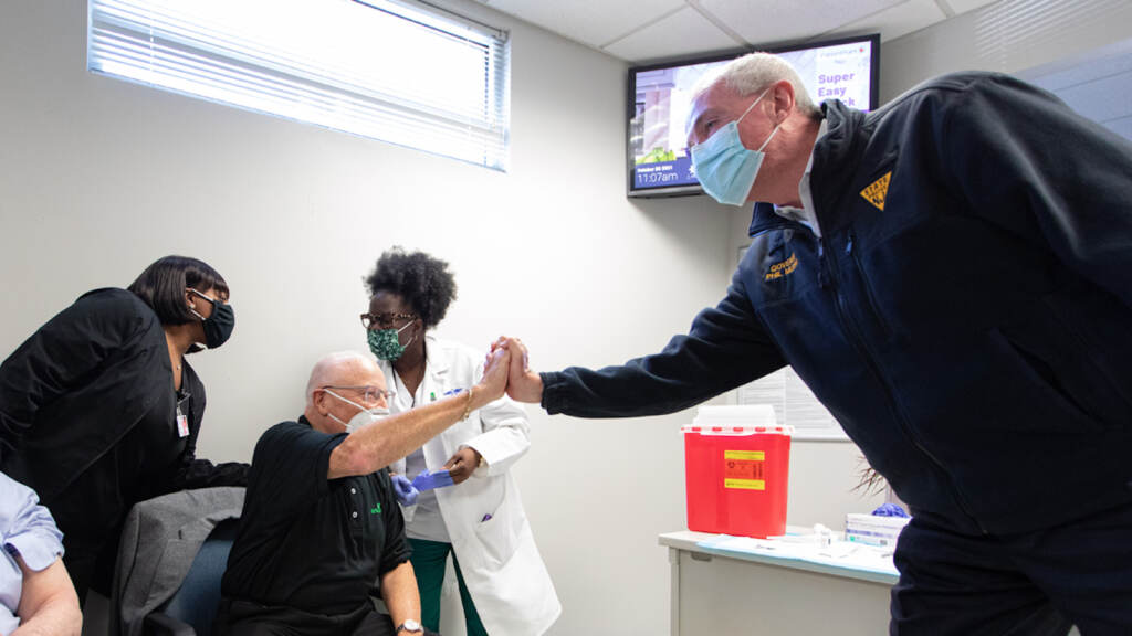 Phil-Murphy-vaccine-booster-clinic-Trenton-Oct.-28-2021 Oct. 28, 2021: Gov. Phil Murphy, right, at a clinic for COVID-19 vaccination booster shots in Trenton. (Rich Hundley/NJ Spotlight News)