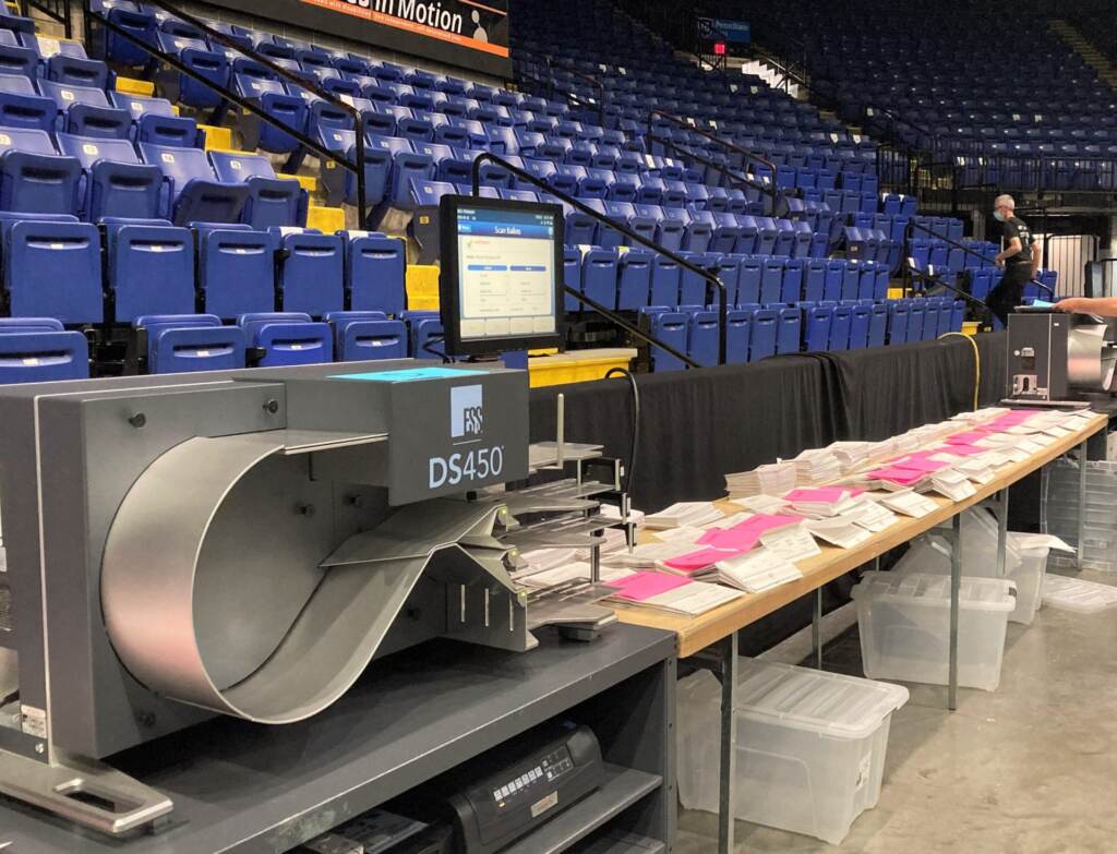 Primary-Mail-in-2021-scaled-e1638299605550-1920×1469 Mail-in ballots from the 2021 primary are ready to be scanned by Berks Election Services. (Courtesy of Stephanie Weaver.)