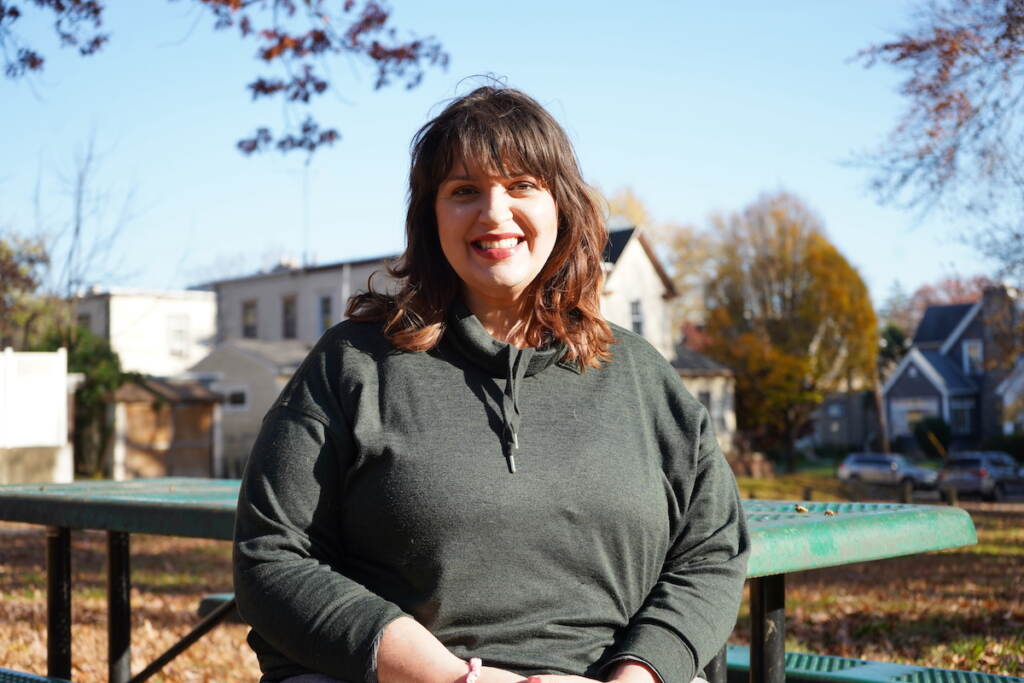 Regina Colburn seated at Belmont Park believes that kindness shouldn't be an exchange — it's actually a political action, something everyone should take part of