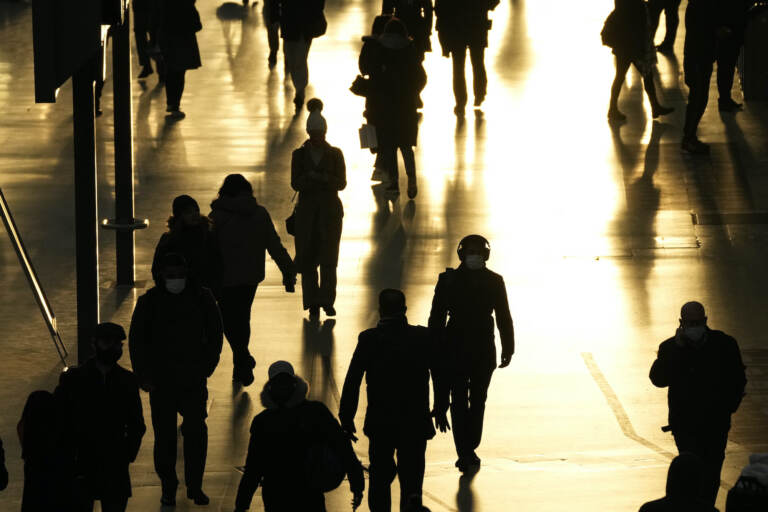 People pass through Waterloo train station