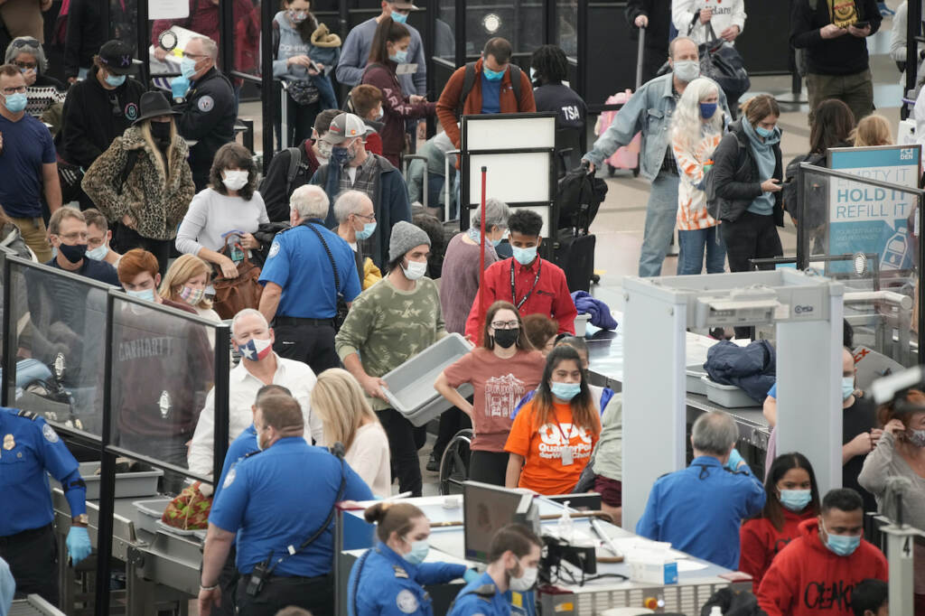 Holiday Travel Denver People line up for a TSA checkpoint at an airport