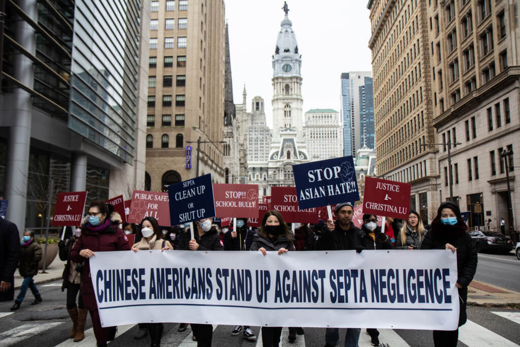 anti-bullying-violence-rally-septa-AAPI-KP-113021-10 Protesters march away from City Hall with a sign that says,