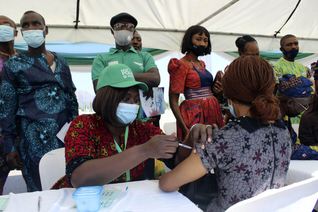 Virus Outbreak New Variant Inequality A woman receives an AstraZeneca COVID-19 vaccination