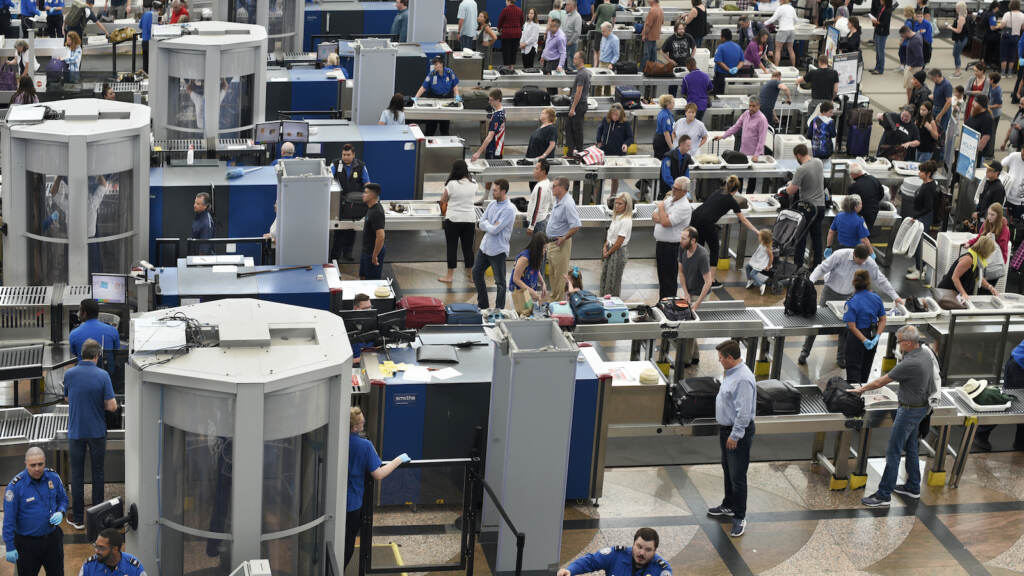 Airplane passengers line up for TSA security screenings