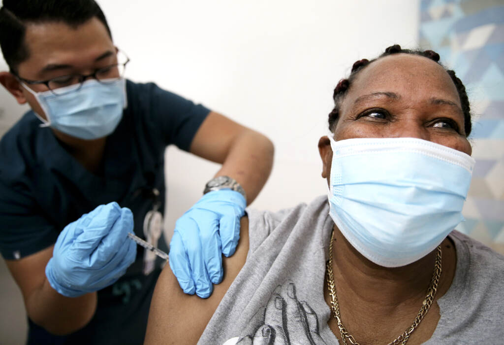 An in-home care worker receives her first dose of the COVID-19 vaccine in February in Los Angeles, Calif. An in-home care worker receives her first dose of the COVID-19 vaccine in February in Los Angeles, Calif.
(Mario Tama/Getty Images)
