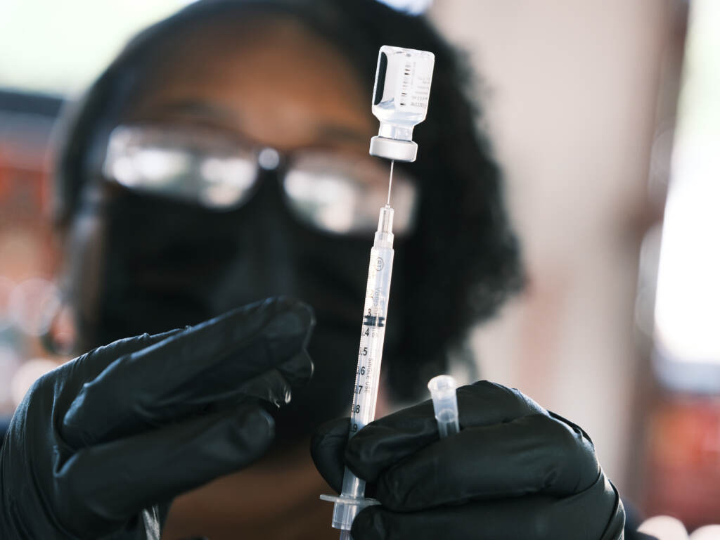 A person prepares to administer a Pfizer COVID vaccine at a clinic in Ferguson, Missouri in August 2021. Merriam-Webster has chosen “vaccine” as the word of the year, citing a sustained surge in lookups. A person prepares to administer a Pfizer COVID vaccine at a clinic in Ferguson, Missouri in August 2021. Merriam-Webster has chosen