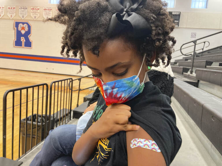 Solome Walker looks down at a bandage on her arm
