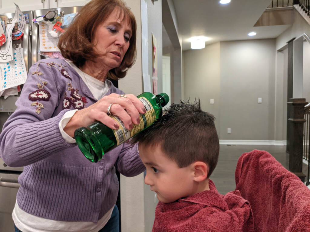 lice-kids-pandemic-111821 Linda Holmes checks the head of a boy for lice