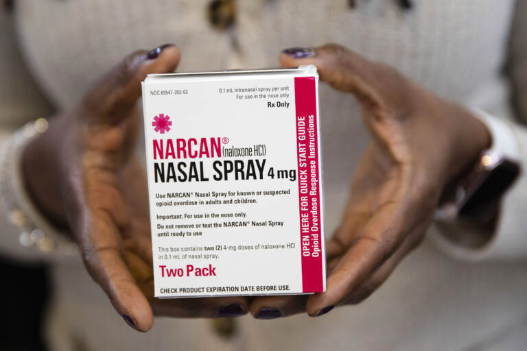 A person holds a box of Narcan spray