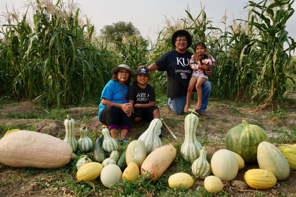 Native tribes have responded to the pandemic with creative ways to stay connected. Veronica Concho and Raymond Concho Jr. grew traditional Pueblo foods and Navajo crops with their grandchildren Kaleb and Kateri Allison-Burbank in Waterflow, N.M. Native tribes have responded to the pandemic with creative ways to stay connected. Veronica Concho and Raymond Concho Jr. grew traditional Pueblo foods and Navajo crops with their grandchildren Kaleb and Kateri Allison-Burbank in Waterflow, N.M.
(Joshuaa Allison-Burbank/NPR)