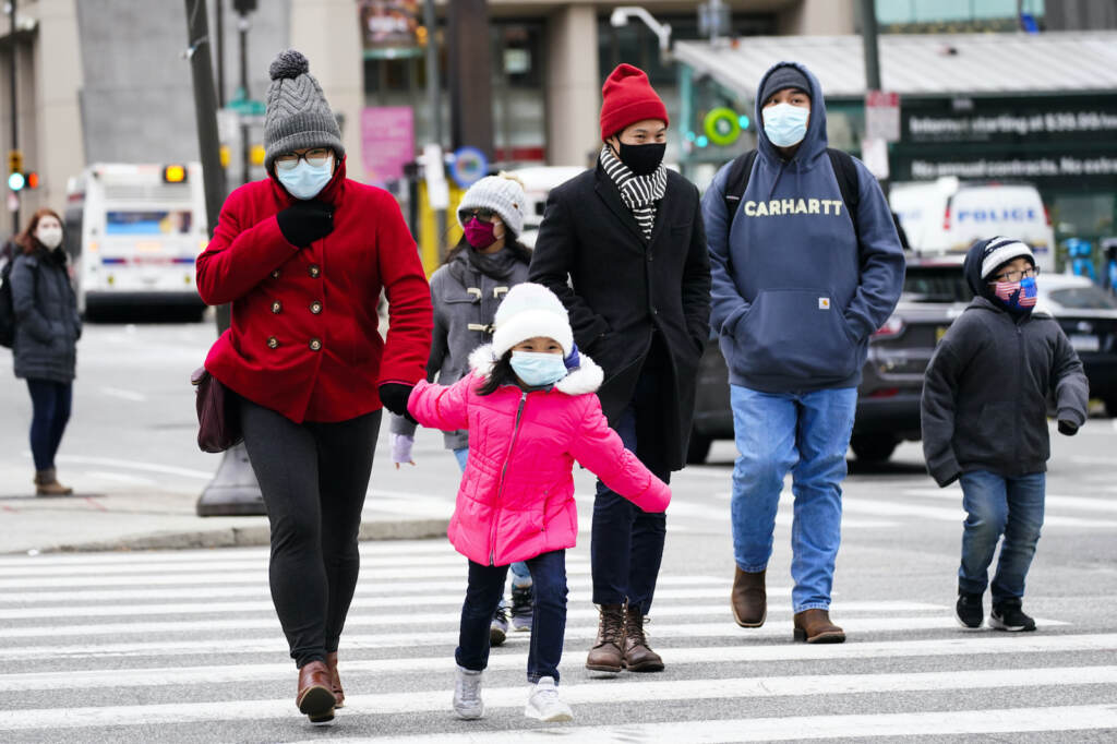 Virus Outbreak Pennsylvania People wearing face masks walk through Philadelphia