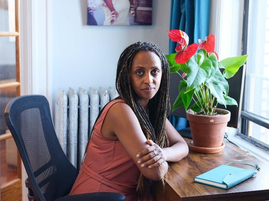 Even doing a few simple tasks can be draining for Semhar Fisseha after her COVID diagnosis. Semhar Fisseha sits at a desk