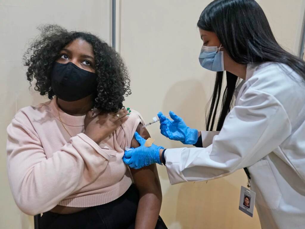 Keidy Ventura, 17, receives her first dose of the Pfizer COVID-19 vaccine in West New York, N.J. Pfizer has asked federal regulators to expand the eligibility for booster shots to include 16- and 17-year-olds. Keidy Ventura receives her first dose of the Pfizer COVID-19 vaccine