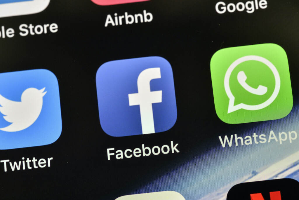 Cybersecurity NSO Group Palestinians Hacked The icons of Facebook and WhatsApp are pictured on an iPhone