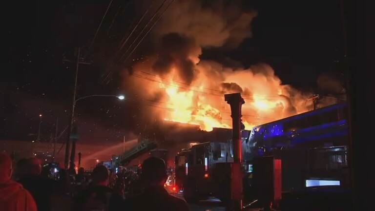 A vacant warehouse is seen aflame