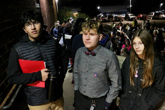 (From left) Anshul Shukla, Seth Soderquist, and Lily Freeman wait in line