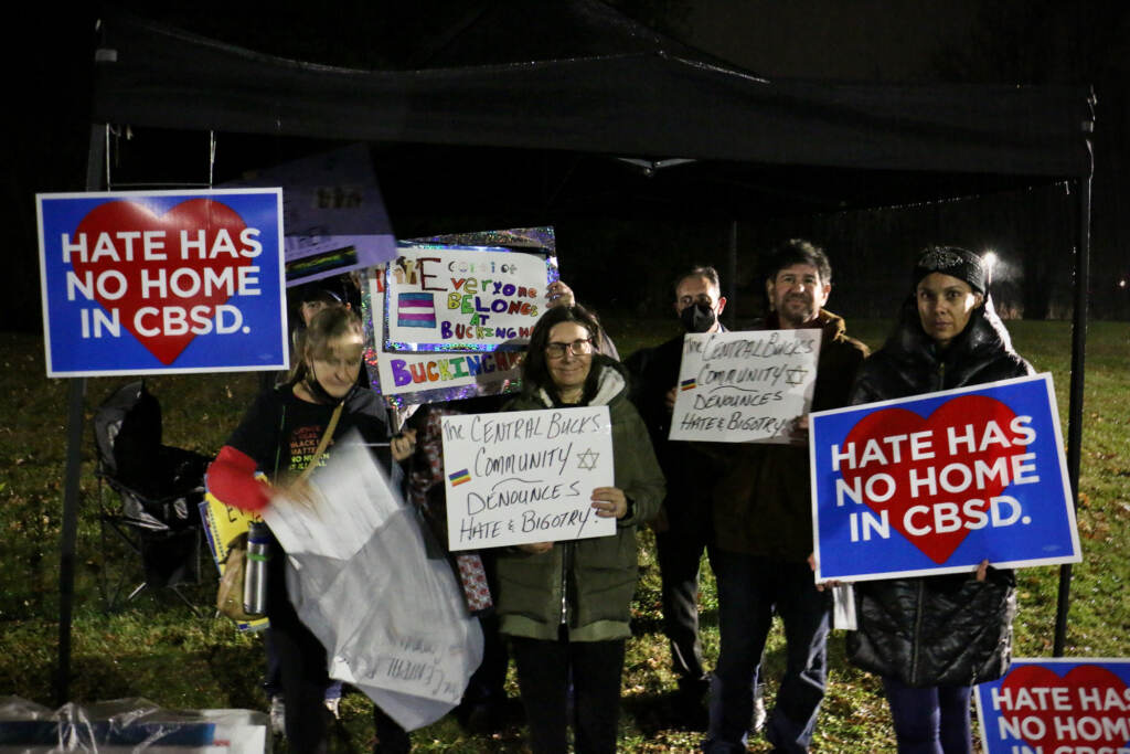 2021 12 06-e lee-doylestown central bucks school district-board meeting parents with signs Demonstrators hold sign sin support of LGBTQ people outside a school board meeting