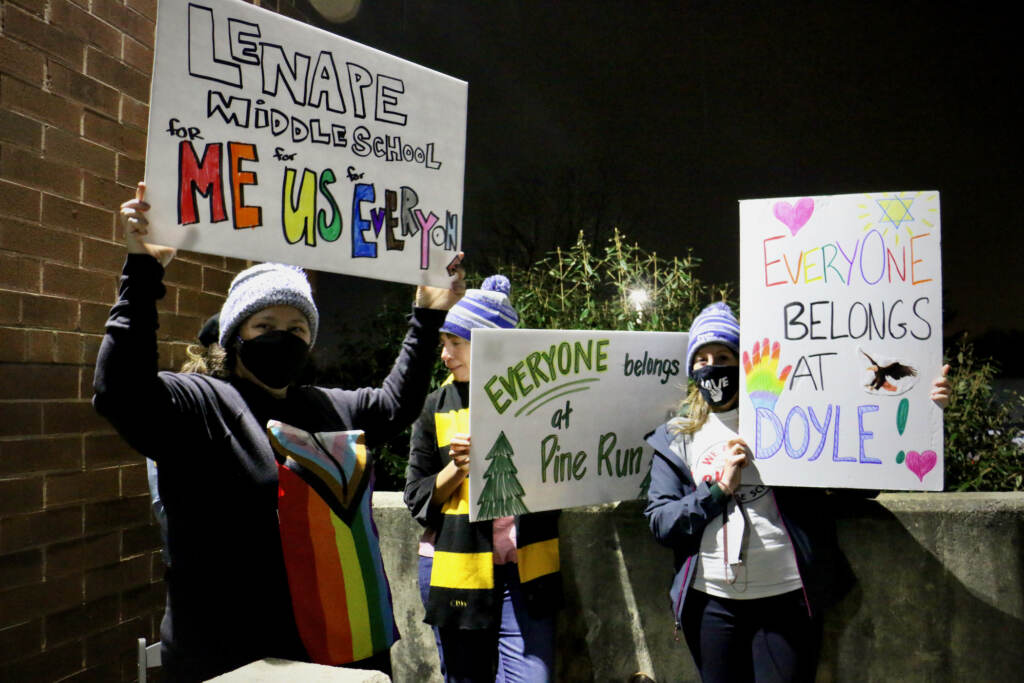2021 12 06-e lee-doylestown central bucks school district-board meeting signs Demonstrators hold sign sin support of LGBTQ people outside a school board meeting