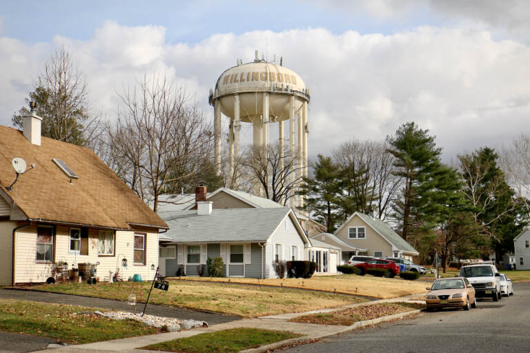 A water tower looms over the Academy Woods neighborhood