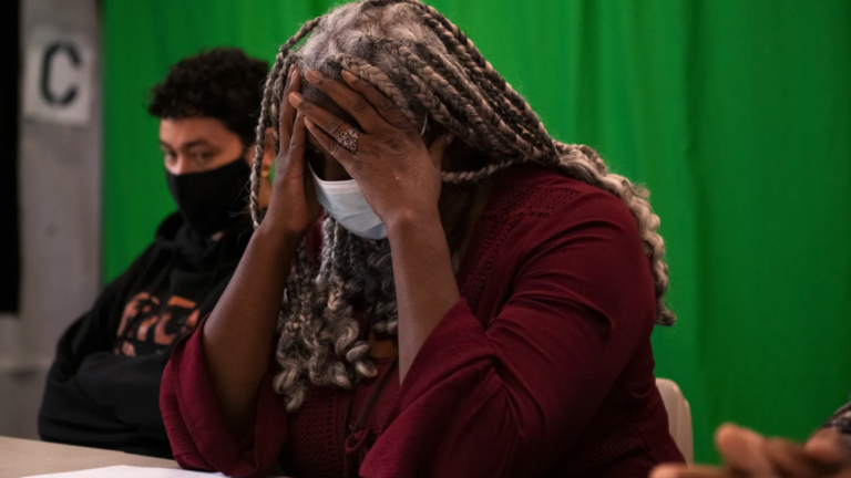 Deana Ramsey, principal at Philadelphia’s Juvenile Justice Services Center School, holds her head in frustration. Students at the school have accounted for a staggering 96 of gun violence victims last school year, the largest amount of any school in the district. (Kriston Jae Bethel for Chalkbeat)