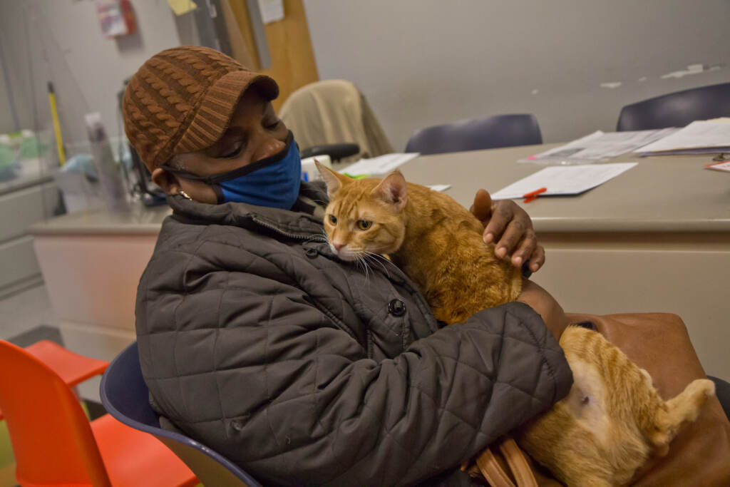 Carolyn Hall holds her cat, Tiger