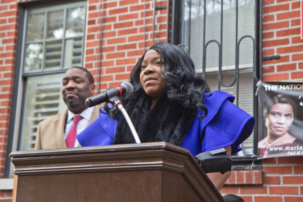 Jillian Patricia Pirtle speaks from a podium outside the Marian Anderson museum