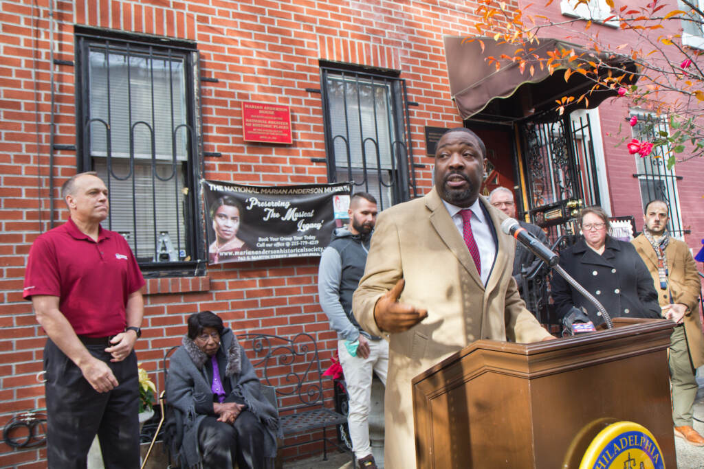 Philadelphia Councilmember Kenyatta Johnson speaks from a podium outside the Marian Anderson museum