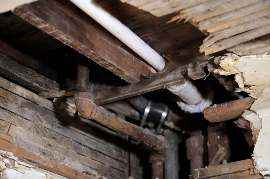 EPA Drinking Water Lead A lead pipe , left, is seen in a hole the kitchen ceiling in the home of Desmond Odom, Thursday, Nov. 8, 2018, in Newark, N.J. AP Photo/Julio Cortez)