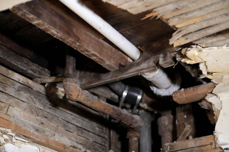 A lead pipe , left, is seen in a hole the kitchen ceiling in the home of  Desmond Odom, Thursday, Nov. 8, 2018, in Newark, N.J. AP Photo/Julio Cortez)