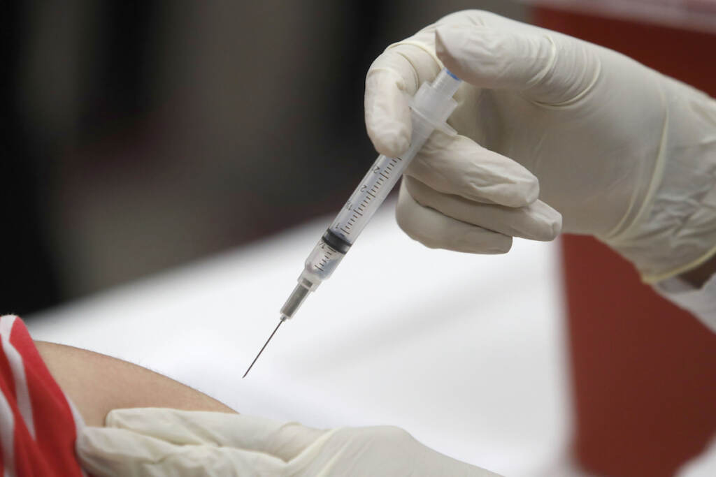 A syringe with an influenza vaccine inside heads to its mark during a flu vaccination at Eastfield College in Mesquite, Texas, Thursday, Jan. 23, 2020. This flu season started early and all but two states reported widespread outbreaks by the week ended Jan. 11, according to the U.S. Centers for Disease Control and Prevention. From 1982 to 2018, the flu most often peaked in February, so there's a good chance the rest of the states will see their cases increase this year