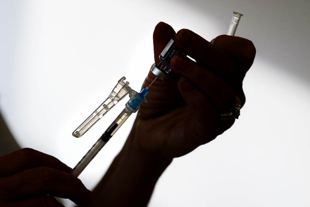 A syringe is prepared with the Pfizer COVID-19 vaccine at a clinic in the Norristown Public Health Center in Norristown, Pa., Tuesday, Dec. 7, 2021