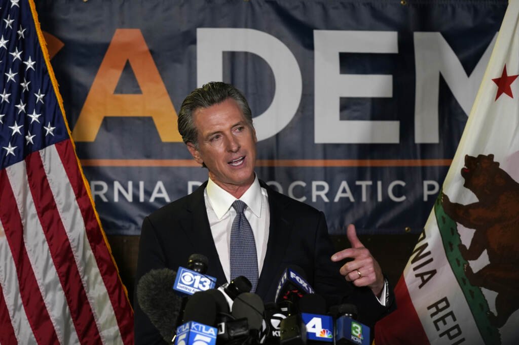 California Gov. Gavin Newsom addresses reporters, after beating back the recall that aimed to remove him from office, at the John L. Burton California Democratic Party headquarters in Sacramento, Calif., Tuesday, Sept. 14, 2021.  The recall election that once threatened Newsom’s political career has instead given it new life, The rare mid-term vote of confidence could fuel an ambitious legislative agenda featuring new corona virus vaccine mandates, housing for the homeless and health insurance for people living in the country illegally. (AP Photo/Rich Pedroncelli)