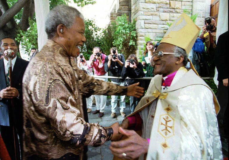 FILE — Retiring Archbishop of Cape Town Desmond Tutu, right, greets President Nelson Mandela at a service in Cape Town, Sunday June 23, 1996 held to celebrate the end of Tutu's tenure as leader of the Anglican Church in South Africa. (AP Photo / Guy Tillim/File)