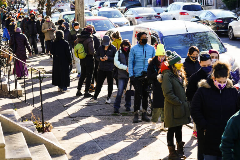 City residents wait in a line extending around the block