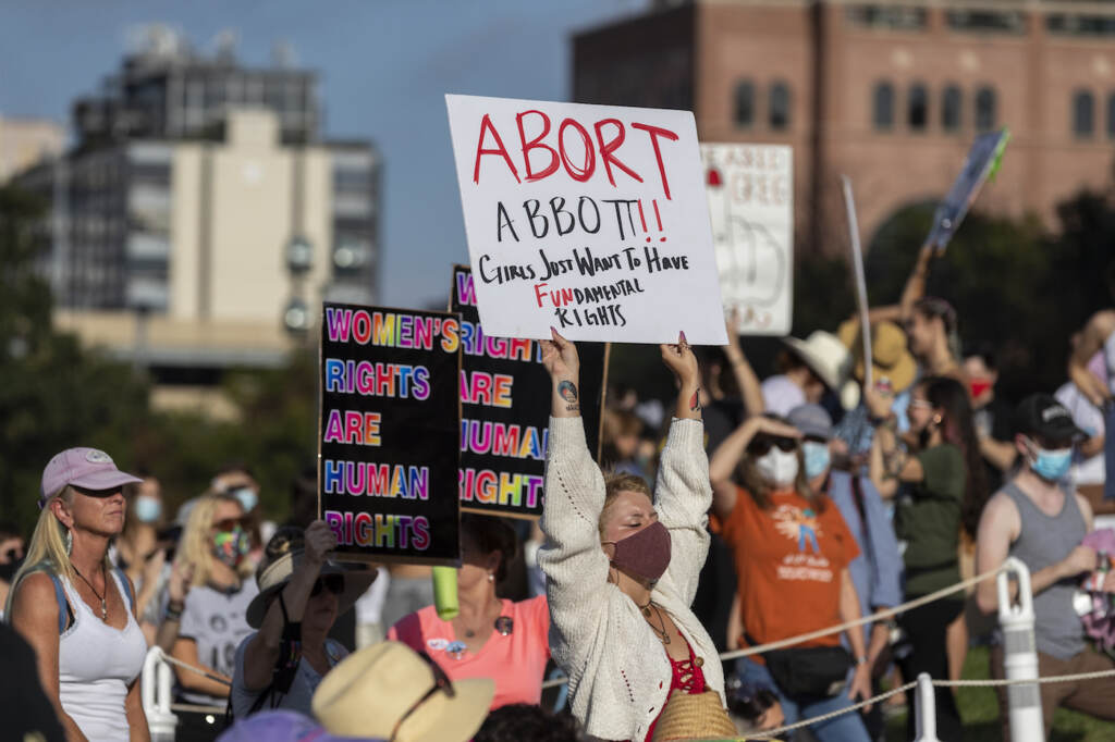 ABORTION STATE LEGISLATURES FILE - People attend the Women's March ATX rally, Saturday, Oct., 2, 2021, at the Texas State Capitol in Austin, Texas. An expected decision by the U.S. Supreme Court in the coming year to severely restrict abortion rights or overturn Roe v. Wade entirely is setting off a renewed round of abortion battles in state legislatures. (AP Photo/Stephen Spillman, File)