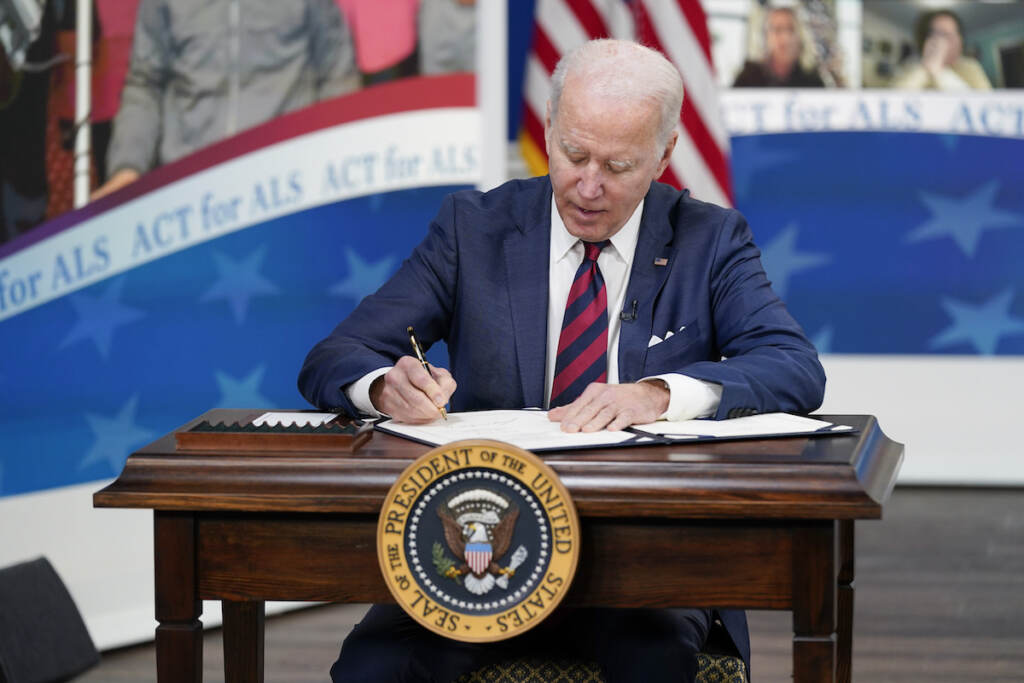 President Joe Biden signs the “Accelerating Access to Critical Therapies for ALS Act” into law during a ceremony in the South Court Auditorium on the White House campus in Washington, Thursday, Dec. 23, 2021.