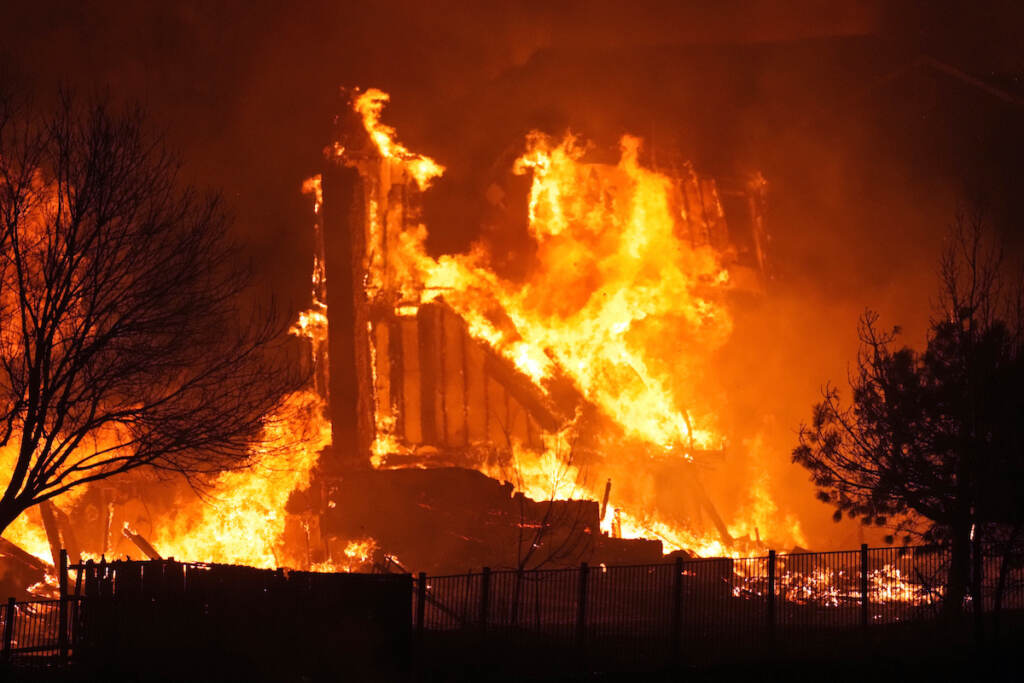 Homes burn as wildfires rip through a development near Rock Creek Village Thursday, Dec. 30, 2021, near Broomfield, Colo. Homes surrounding the Flatiron Crossing mall were being evacuated as wildfires raced through the grasslands as high winds raked the intermountain West