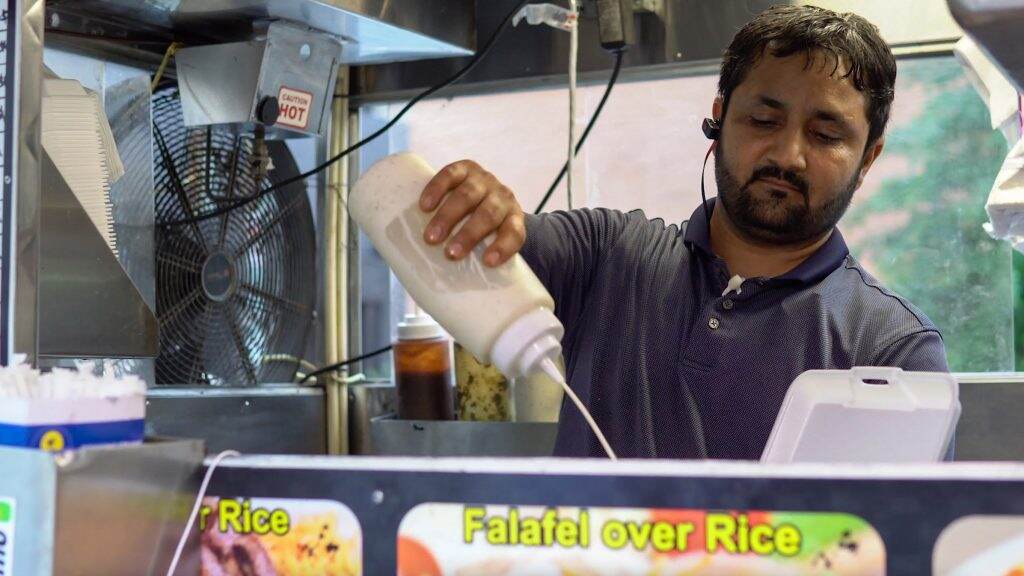 Aamir Khan, who runs a cart at 33rd and Market streets, is glad students are back NOEL CHACKO, JACOB SMOLLEN, KAVEEN HAROHALLI