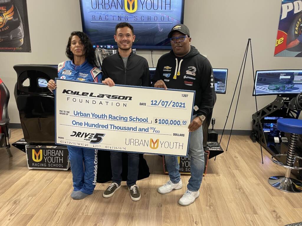 (From left) Michelle Martin, Kyle Larson and Anthony Martin pose with a check from the Kyle Larson Foundation at the Urban Youth Racing School (From left) Michelle Martin, Kyle Larson and Anthony Martin pose with a check from the Kyle Larson Foundation at the Urban Youth Racing School