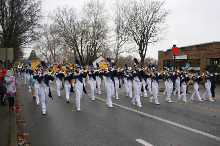 The Downingtown Blue and Gold Band leads the Good Neighbor Christmas Parade. (Robby Brod/WHYY)